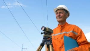 experienced survey specialist stands near dumpy level