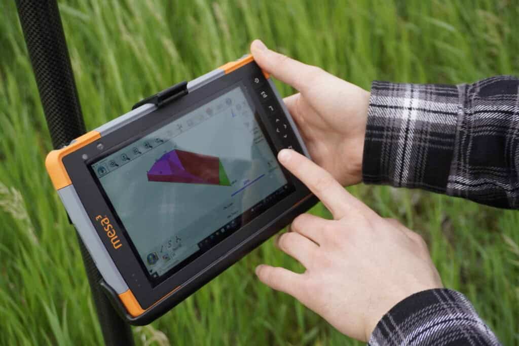 Surveyor collecting field data with FieldGenius on a Juniper Mesa 3 tablet.