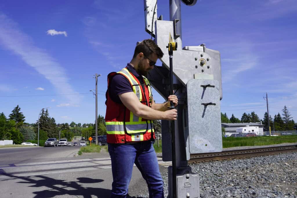 Surveyor adjusting a telescopic prism pole during field surveying work