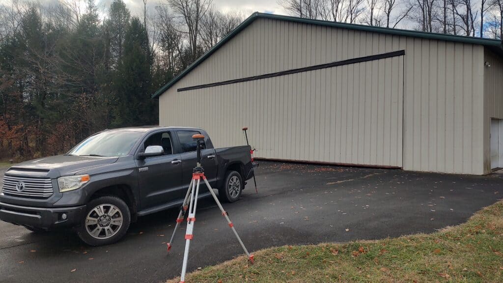 RTK GNSS base station on tripod transmitting real-time corrections to rover