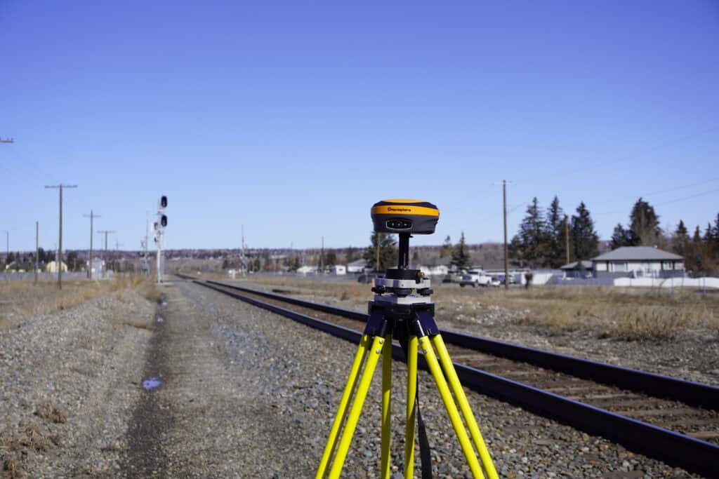 A hemisphere s631 base station by railroad tracks.