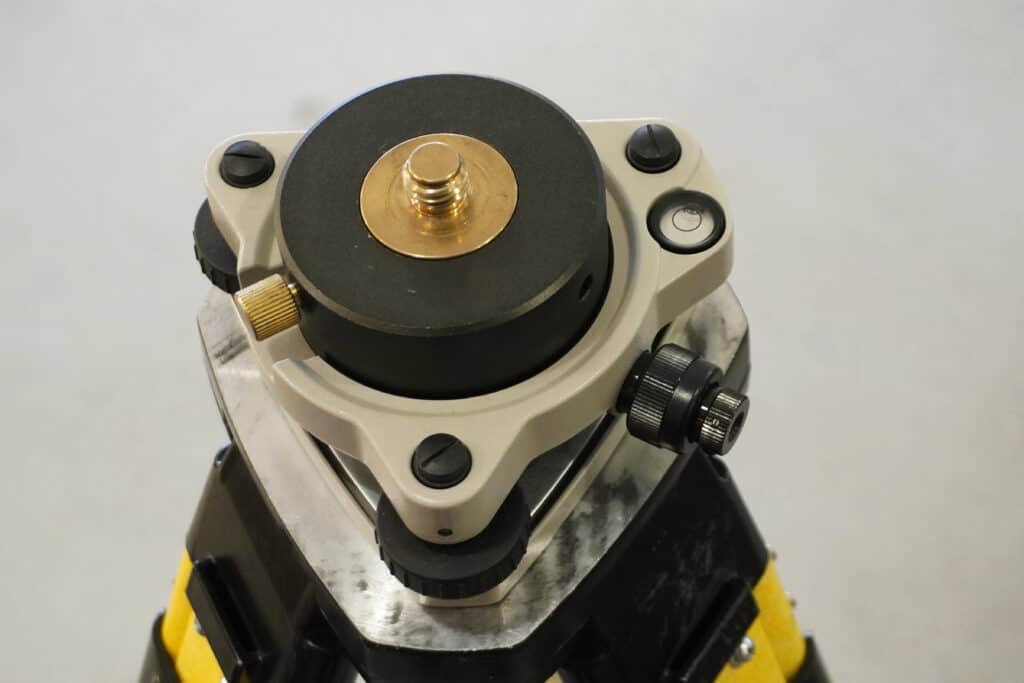 Survey tribrach with leveling screws and optical plummet detail